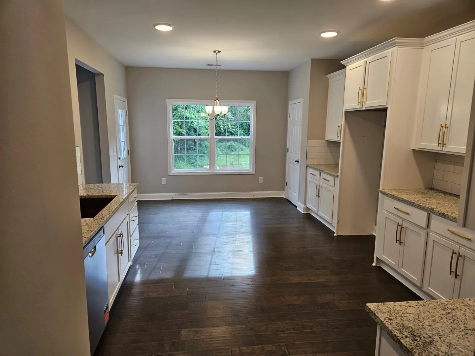 Finished kitchen with white cabinets by Peters Prestigious Properties Inc.
